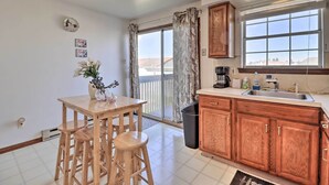 A kitchen with wooden cabinets, a sink, and a window with a view. - 2 Mi to Dtwn Allentown Shops & Eats! Cozy Home (Allentown)