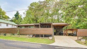A two-story house with a covered patio and a fenced yard. - Walk to Bathhouse Row: Dog-friendly Home! (Hot Springs)