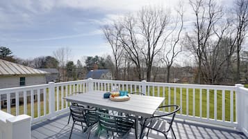 Enjoy al fresco dining on the deck with a view of the surrounding landscape.
