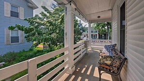 A porch with a bench, white railings, and a view of neighboring houses. - 9 Mi to Midtown Harrisburg: Cottage w/ Deck (Harrisburg)