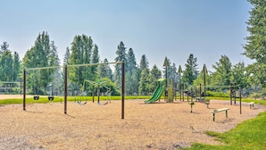 A playground with swings, a slide, and a climbing structure.