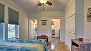 A bedroom with a bed, a ceiling fan, a dresser, and a nightstand. - Lawrence Area Vacation Rental 15 Mi to Topeka! (Lecompton)
