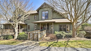 A two-story house with a porch, a wooden fence, and a star decoration. - Beautiful Lake Glenville Townhome w/ Mountain View (Cashiers)