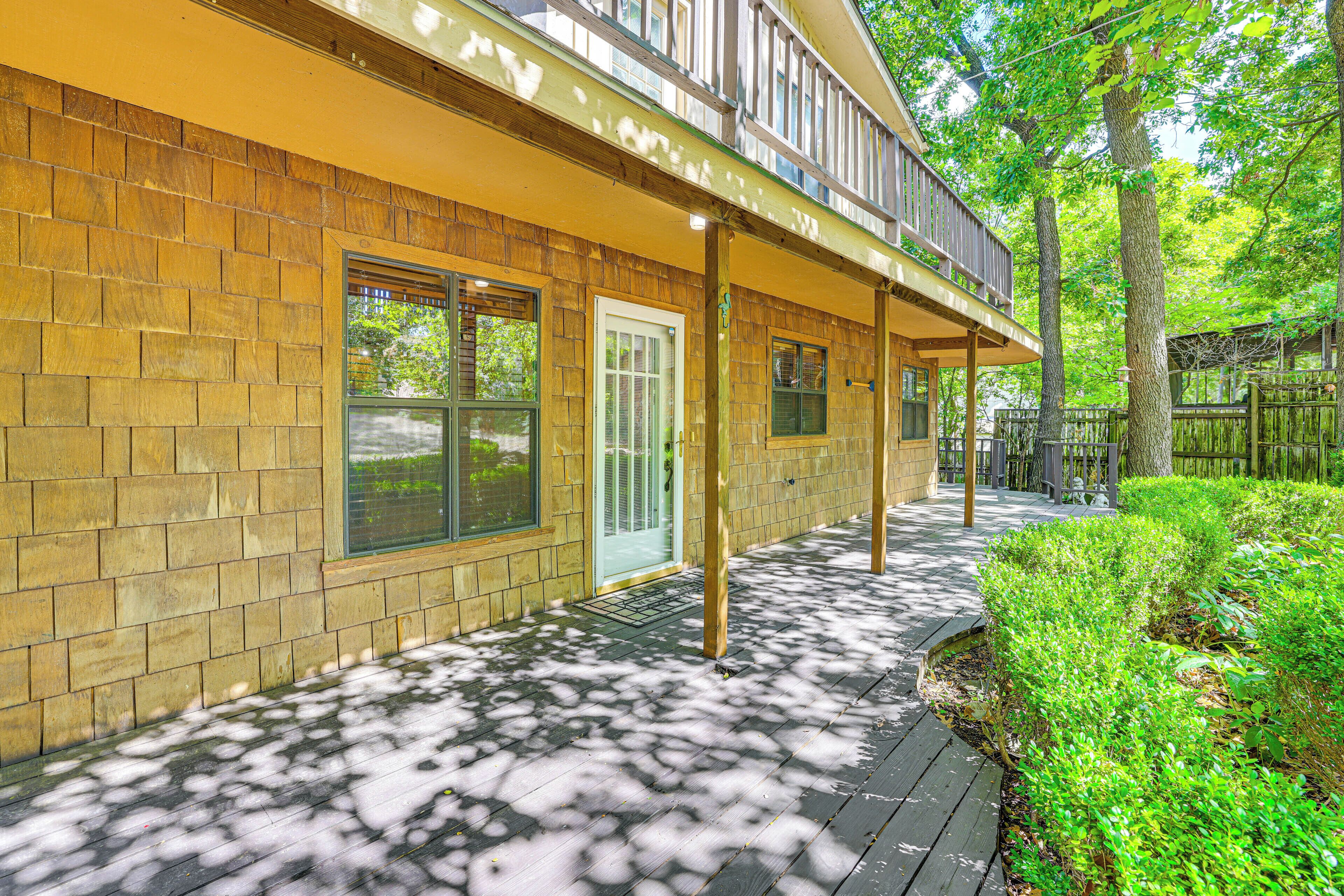 A wooden exterior with a covered porch and a door.