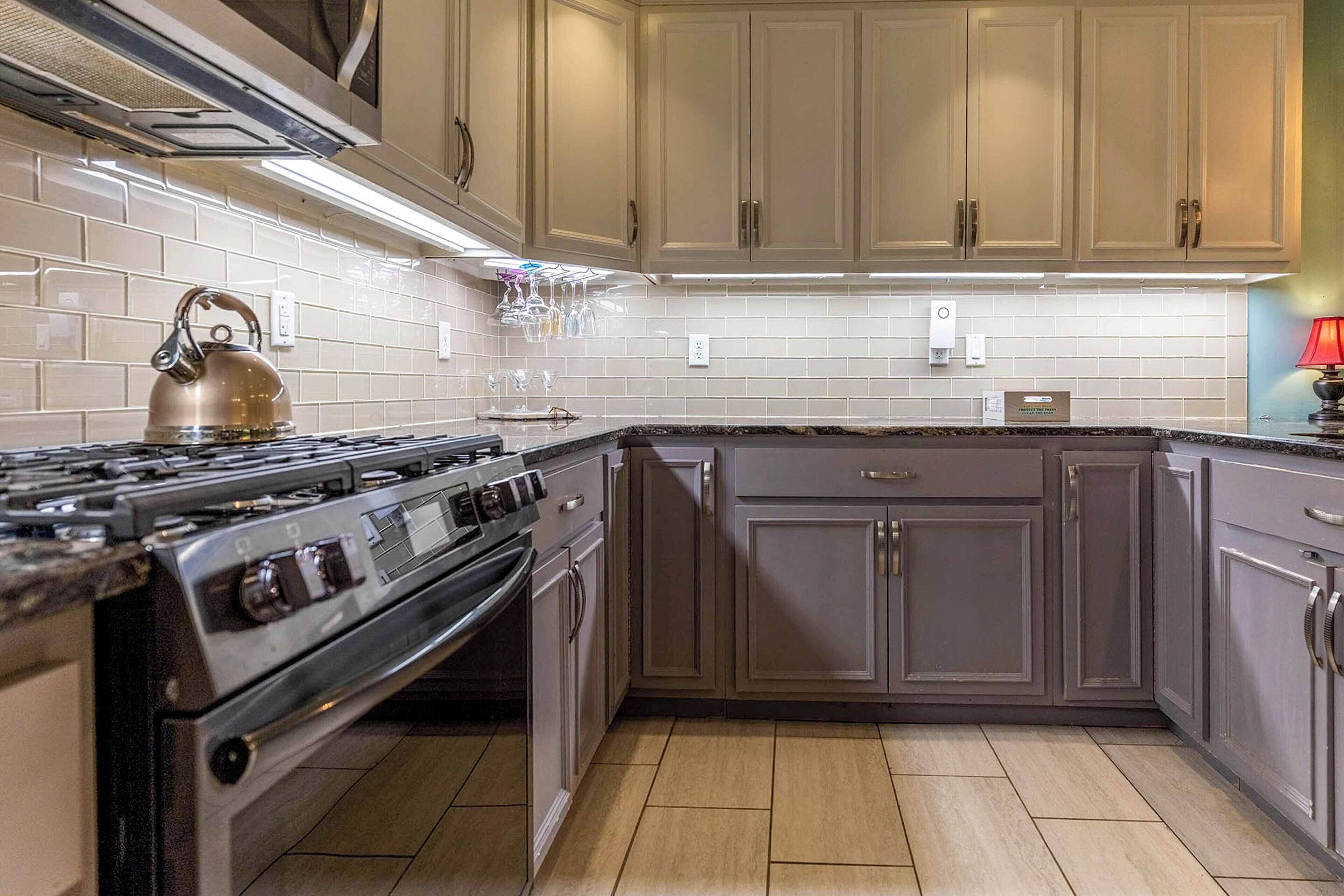 A kitchen with a stove, oven, and cabinets.