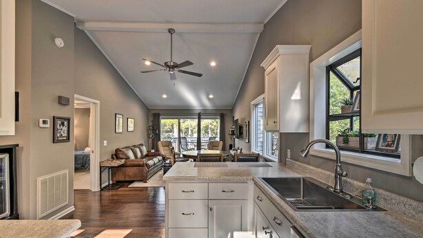A spacious kitchen with a central island, a built-in sink, and a ceiling fan. - Pinehurst Gem on Golf Course & Putting Green! (Pinehurst)