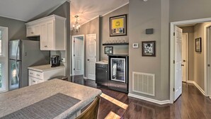 A modern kitchen with white cabinetry, a granite countertop, and a built-in refrigerator. - Pinehurst Gem on Golf Course & Putting Green! (Pinehurst)