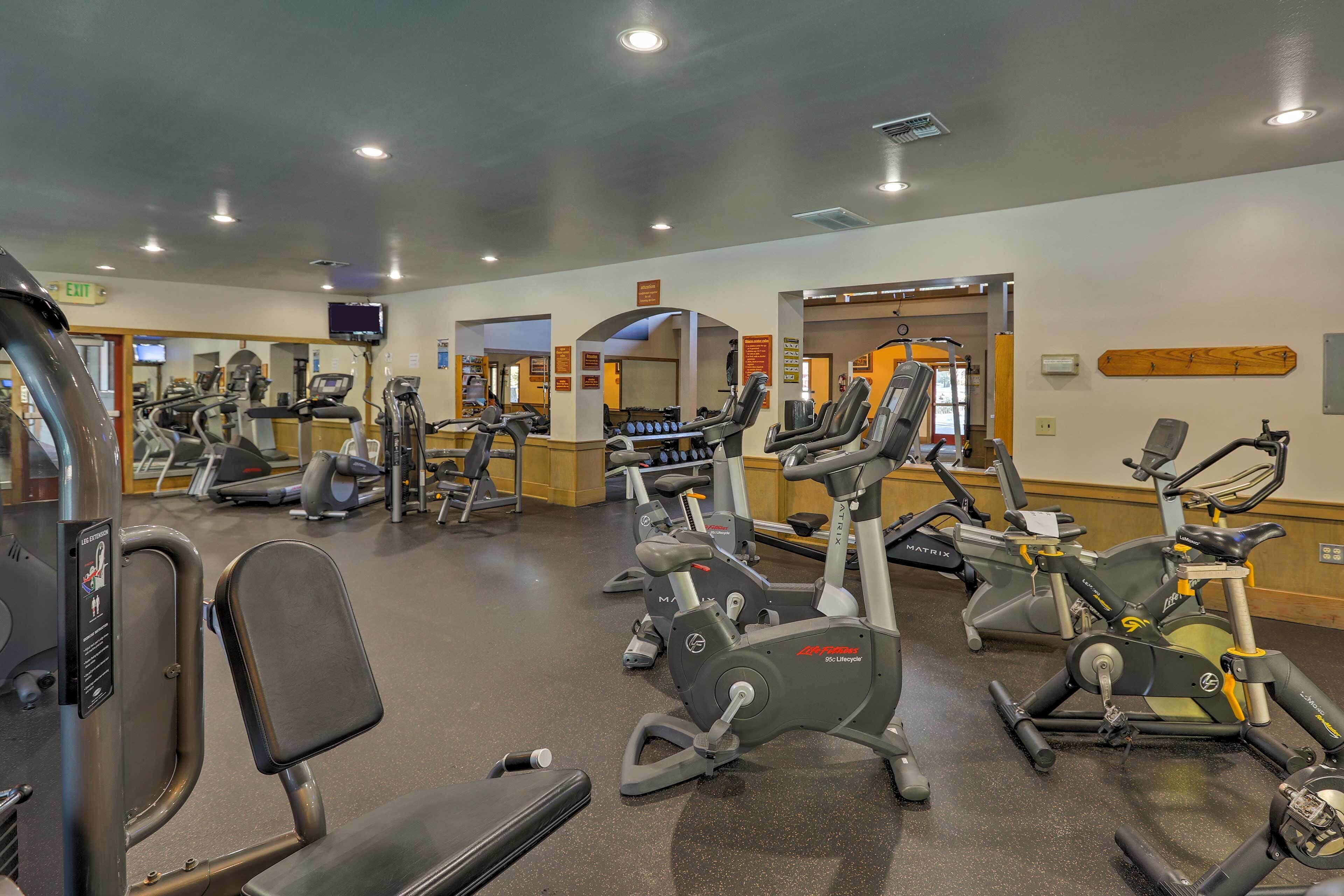 A gym with various exercise equipment, including treadmills and stationary bikes.