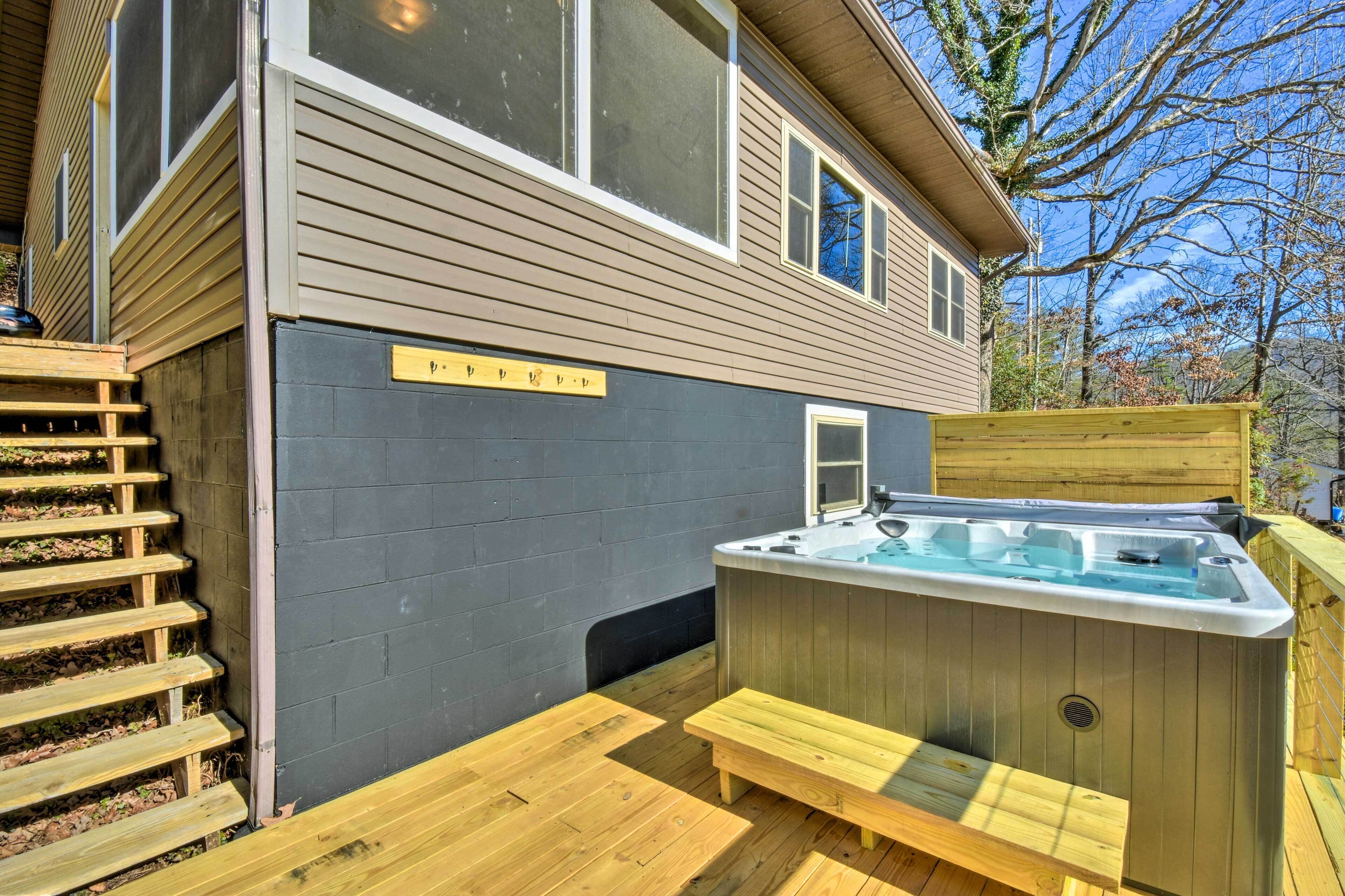 A hot tub with a wooden deck and a wooden staircase leading to a door marked "Private."