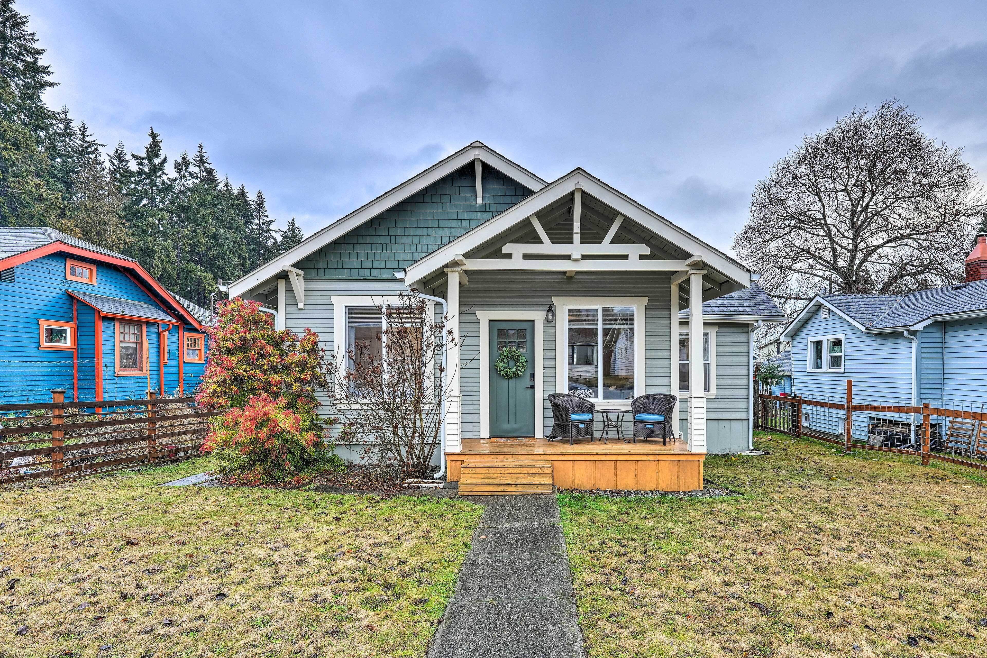 A single-story house with a front porch, a small deck, and a front yard.