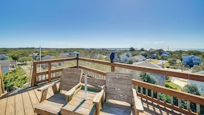 A wooden deck with a view of a residential area. - Spacious Kill Devil Hills Getaway w/ 3 Decks! (Kill Devil Hills)