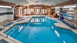 An indoor swimming pool with a wooden interior, tiled flooring, and a lifeguard chair. - Lincoln Escape w/ Deck: 1 Mi to Loon Mountain! (Lincoln)