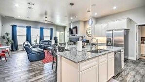 A modern kitchen with granite countertops, stainless steel appliances, and a central island. - Modern Amarillo House w/ Fire Pit + Hot Tub! (Amarillo)