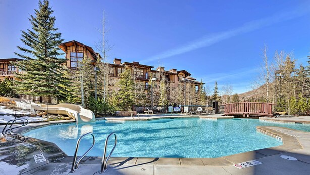 A resort with a swimming pool, wooden buildings, and a ski lift. - Solitude Creekside Condo-closest to Ski Lift! (Solitude)