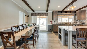 A spacious kitchen with a long dining table, wooden chairs, and a central island. - Spacious Tierra Amarilla Ranch House w/ Deck! (Tierra Amarilla)
