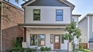 A two-story house with a front porch, brick exterior, and a well-maintained lawn. - Spacious Houston Home ~ 16 Mi to NRG Stadium! (Houston)