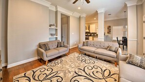 A living room with two sofas, a patterned rug, and a ceiling fan. - Spacious Houston Home ~ 16 Mi to NRG Stadium! (Houston)
