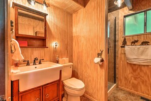 A wooden-paneled bathroom with a sink, toilet, and shower. - Twain Harte Mountain Cabin w/ Deck - 3 Mi to Dtwn (Twain Harte)
