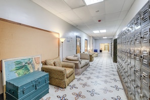 A hallway with lockers, a map on the wall, and a patterned floor. - Access to Warrior Trail! ATV Base Camp in Gary (Gary)