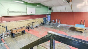 A room with a foosball table, exercise equipment, and a pool table. - Access to Warrior Trail! ATV Base Camp in Gary (Gary)