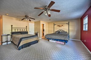 A bedroom with two beds, a ceiling fan, a nightstand, and a window. - Serene Blue Ridge Getaway in Galax w/ Yard! (Galax)