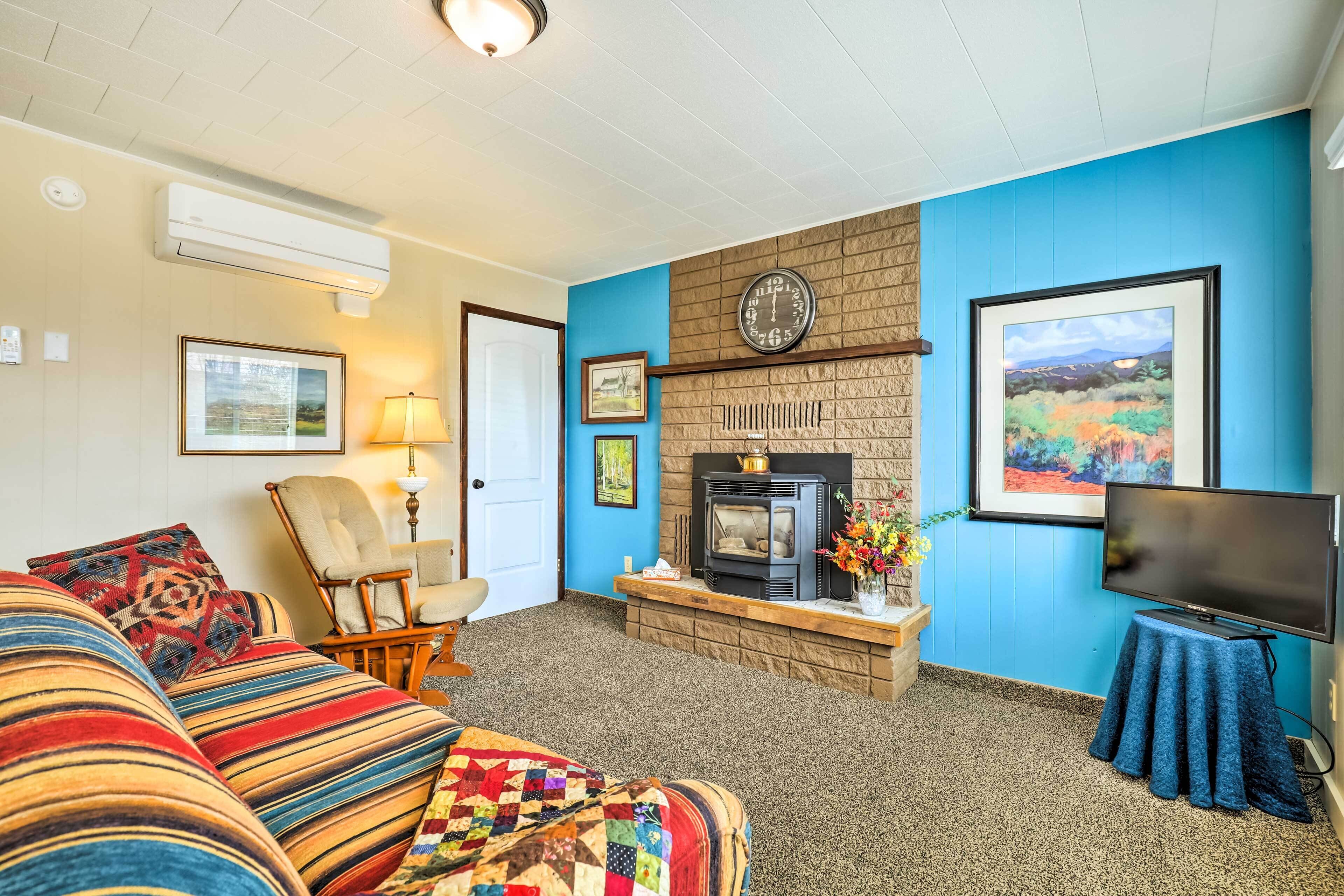 A cozy living room with a fireplace, a television, and comfortable seating.