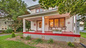 A two-story house with a red porch and white columns. - Whimsical Lancaster House w/ Porch Near Amish Farm (Lancaster)