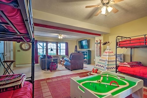 A room with bunk beds, a play area with a train set, a television, and a fireplace. - Waynesville Escape - Mtn Cabin Above the Clouds! (Waynesville)