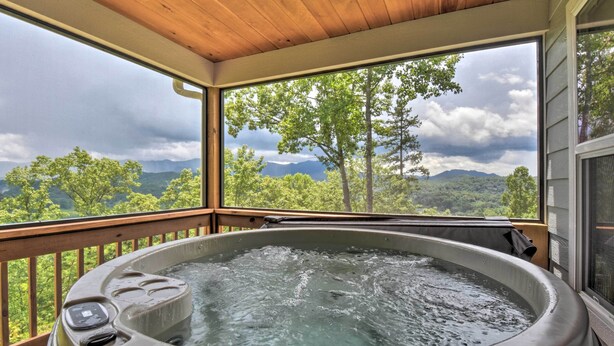 A hot tub on a wooden deck with a view of mountains and trees. - Hot Tub Relaxation & Mtn View: Sky Blue Overlook (Marble)