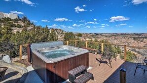 A hot tub on a wooden deck with a scenic view of a canyon. - Charming Texas Home w/ Stunning Canyon Views! (Canyon)