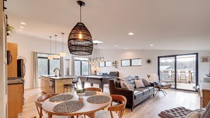 A spacious living area with a dining table, sofa, and a pool table. - Clam Lake Vacation Rental w/ Deck & Shared Dock! (Bellaire)