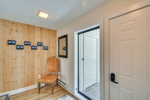 A wooden wall with a chair and a door. - Private Ski Retreat in Avon: Eagle River Views! (Avon)