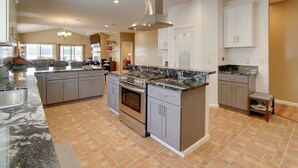 A spacious kitchen with granite countertops, stainless steel appliances, and ample storage cabinets. - Clearlake Vacation Rental w/ Nearby Lake Access! (Clearlake)