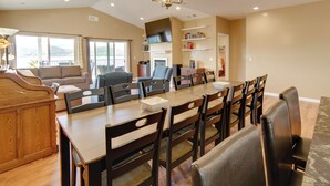 A spacious living room with a large dining table, comfortable seating, and a fireplace. - Clearlake Vacation Rental w/ Nearby Lake Access! (Clearlake)