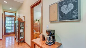 A cozy room with a wooden coffee table, a coffee maker, a mirror, and a chalkboard with a heart drawing. - 5 Mi to Dtwn: Serene Couple's Retreat in Franklin! (Franklin)