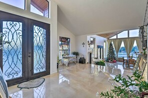 A spacious living area with a polished floor, a Christmas tree, and a 'WELCOME' sign.