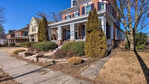 A two-story house with a front porch, a brick facade, and a well-maintained lawn. - Gettysburg Area Retreat, 12 Mi to Nat'l Park! (New Oxford)