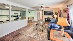 A spacious living room with a large sofa, a coffee table, and a dining area in the background. - Lovely Moshannon Ground Apartment w/ Fire Pit (Moshannon)