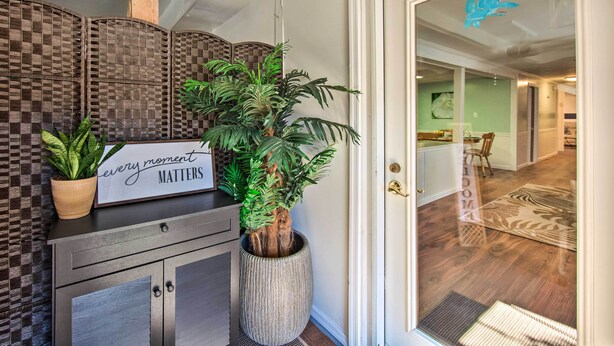 A foyer with a potted plant, a sign reading "every moment matters," and a view into the interior. - Lovely Moshannon Ground Apartment w/ Fire Pit (Moshannon)