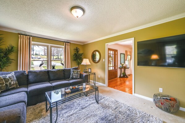 A living room with a sofa, coffee table, and a TV.