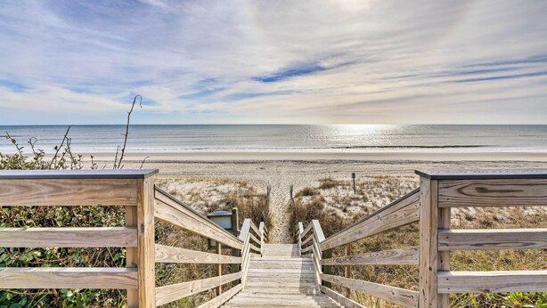 A wooden staircase leading to a beach with a clear view of the ocean. - Ocean Club Condo w/ Community Pool & Hot Tub (Atlantic Beach)