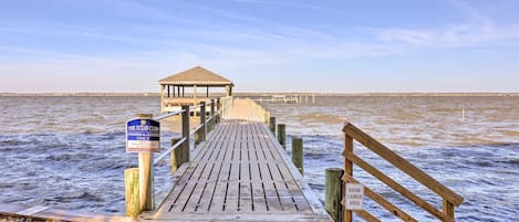 A wooden pier leading to a gazebo with a sign indicating it's for owners and guests only.
