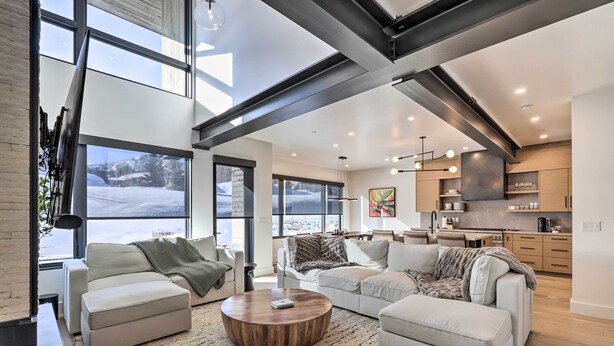 A spacious living room with large windows, a modern kitchen, and a cozy seating area. - Luxe Park City Townhome w/ Hot Tub: 1/2 Mi to Lift (Park City)