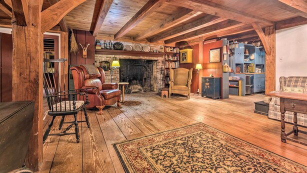 A rustic wooden interior with a fireplace, leather chairs, and a bookshelf. - 10 Mi to Hot Springs Natl Park: Home w/ Grill! (Hot Springs)