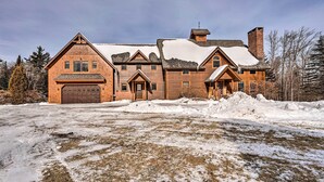 A large, multi-story wooden house with a garage, surrounded by snow. - Secluded Vermont Retreat: Outdoor Pool & Deck (West Wardsboro)