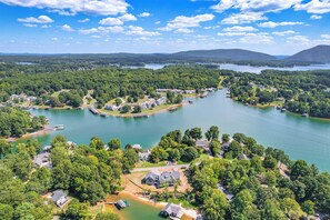 An aerial view of a lakeside community with houses, docks, and boats. - Couples Smith Mtn Lake Getaway w/ Private Beach (Huddleston)