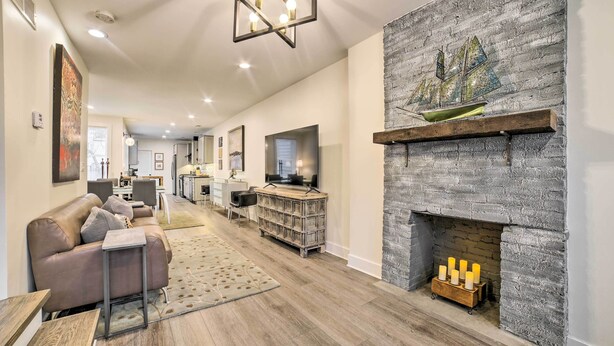 A modern living room with a fireplace, a sofa, a coffee table, and a television. - Pittsburgh Home: Walkable Location! (Pittsburgh)