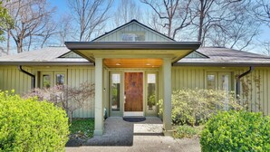 A single-story house with a front porch, a wooden door, and a small overhang above the entrance. - Spacious Prospect Cottage w/ Deck & Scenic Views (Prospect)