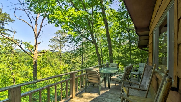 A wooden deck with outdoor furniture, surrounded by trees. - Secluded 'mountain Home' 12 Mi to Tsali Area (Robbinsville)