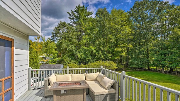 A covered deck with outdoor furniture and a fire feature. - Woodstock Getaway w/ Hot Tub ~ 2 Mi to Dtwn! (Woodstock)